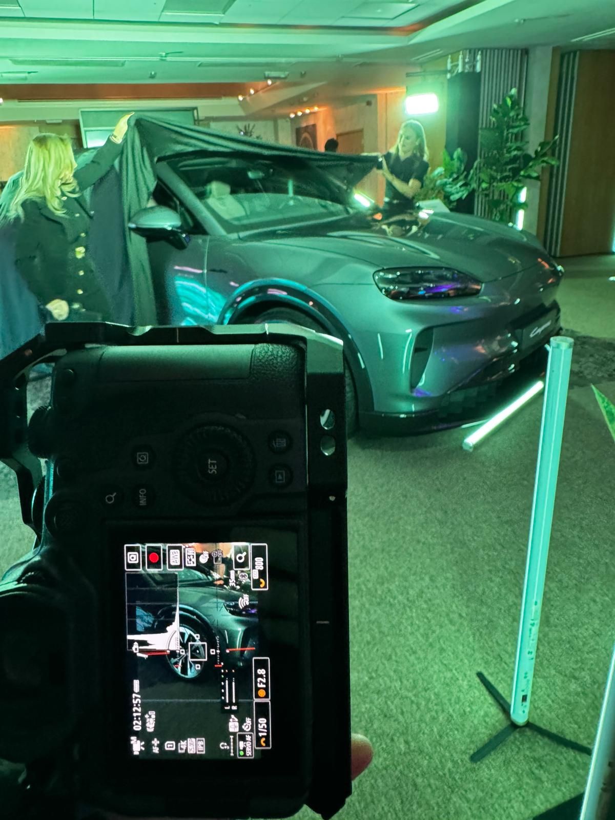 Multiple camera display screens show different angles of a dark interior space with green lighting effects.