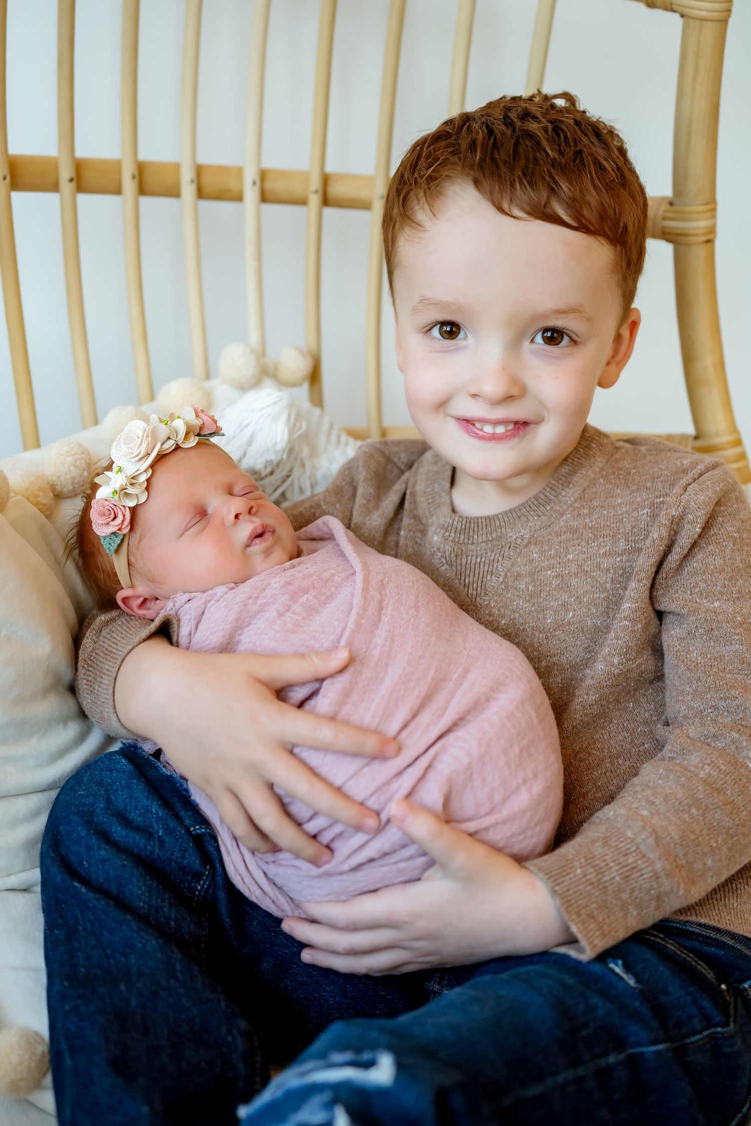 Three candid photos showing siblings holding and bonding with a baby in pink clothing.