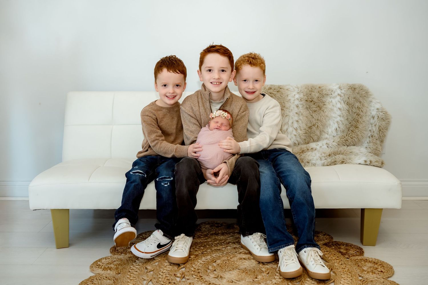 A series of four candid family portrait shots showing playful moments on a light colored couch.