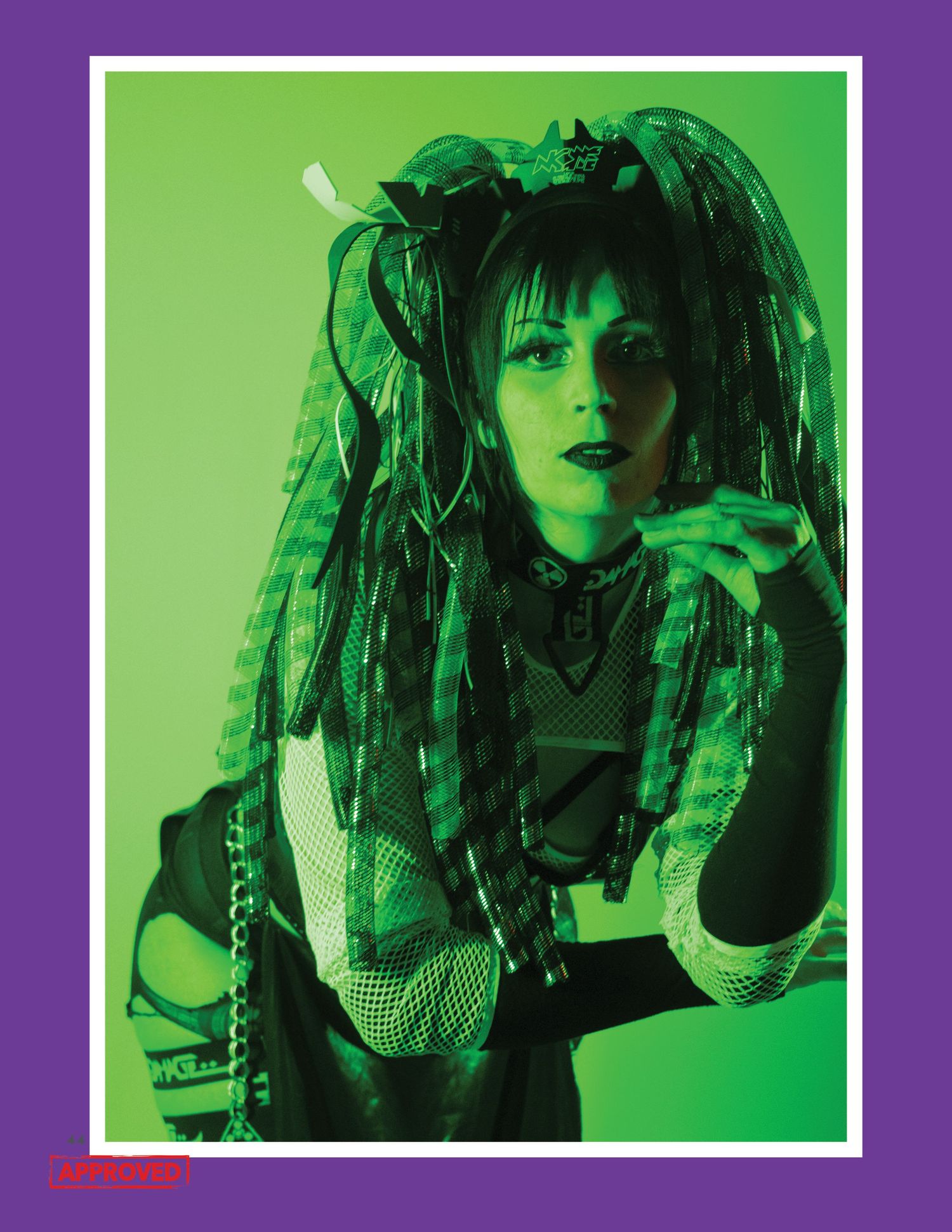 Alternative style fashion photo with green lighting and dramatic gothic aesthetic.