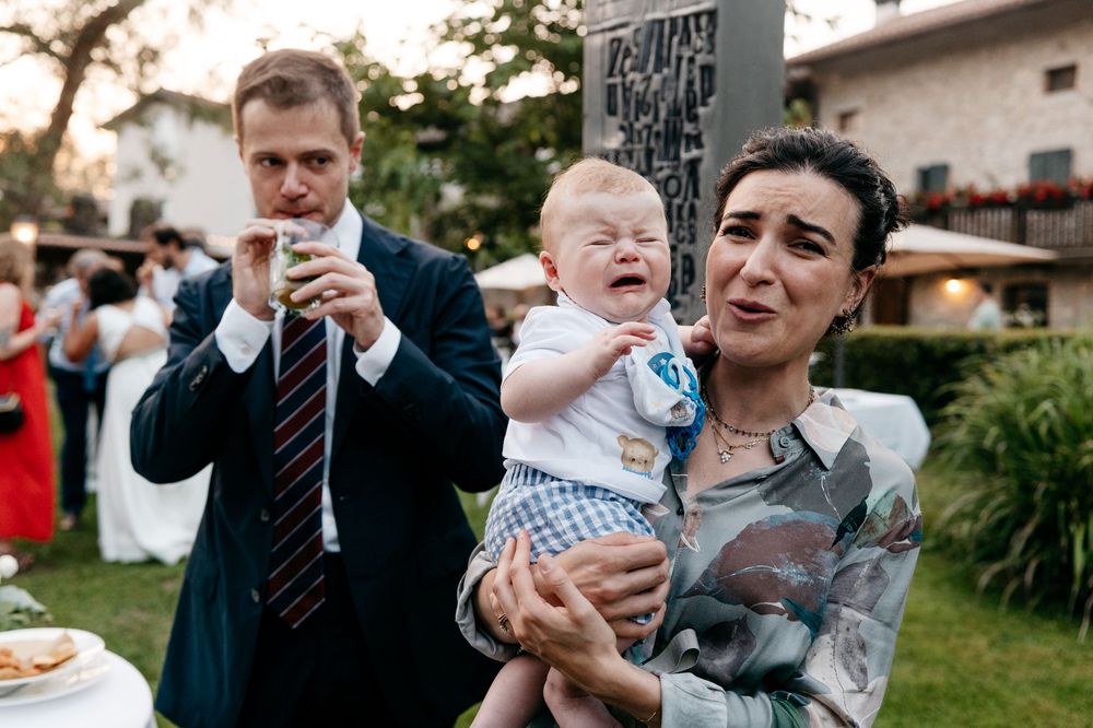 A candid outdoor reception moment showing guests enjoying themselves at a garden wedding.
