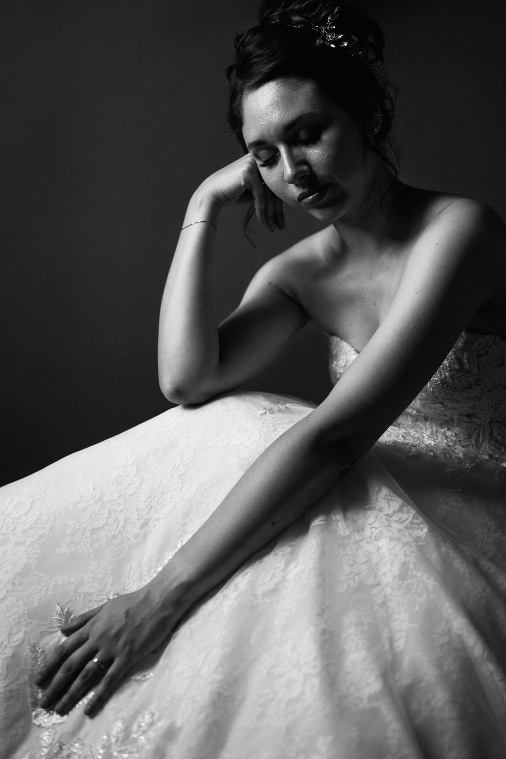 A black and white artistic series of bridal portraits showing details of a lace wedding gown.