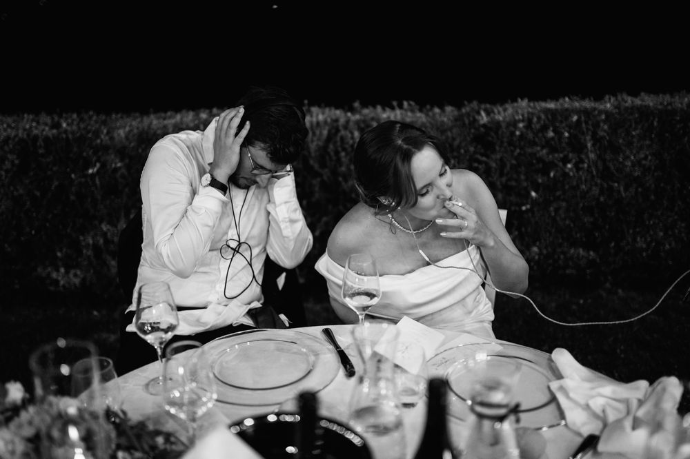 Black and white photo of people dancing together at a wedding reception.
