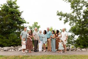 A panoramic sequence of wedding guests gathering outdoors on a sunny day against a natural landscape backdrop.