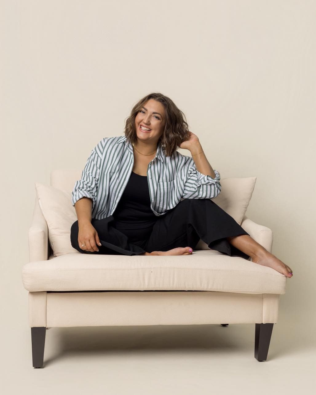 Lifestyle photo sequence of someone lounging casually on a white modern sofa wearing striped shirt.