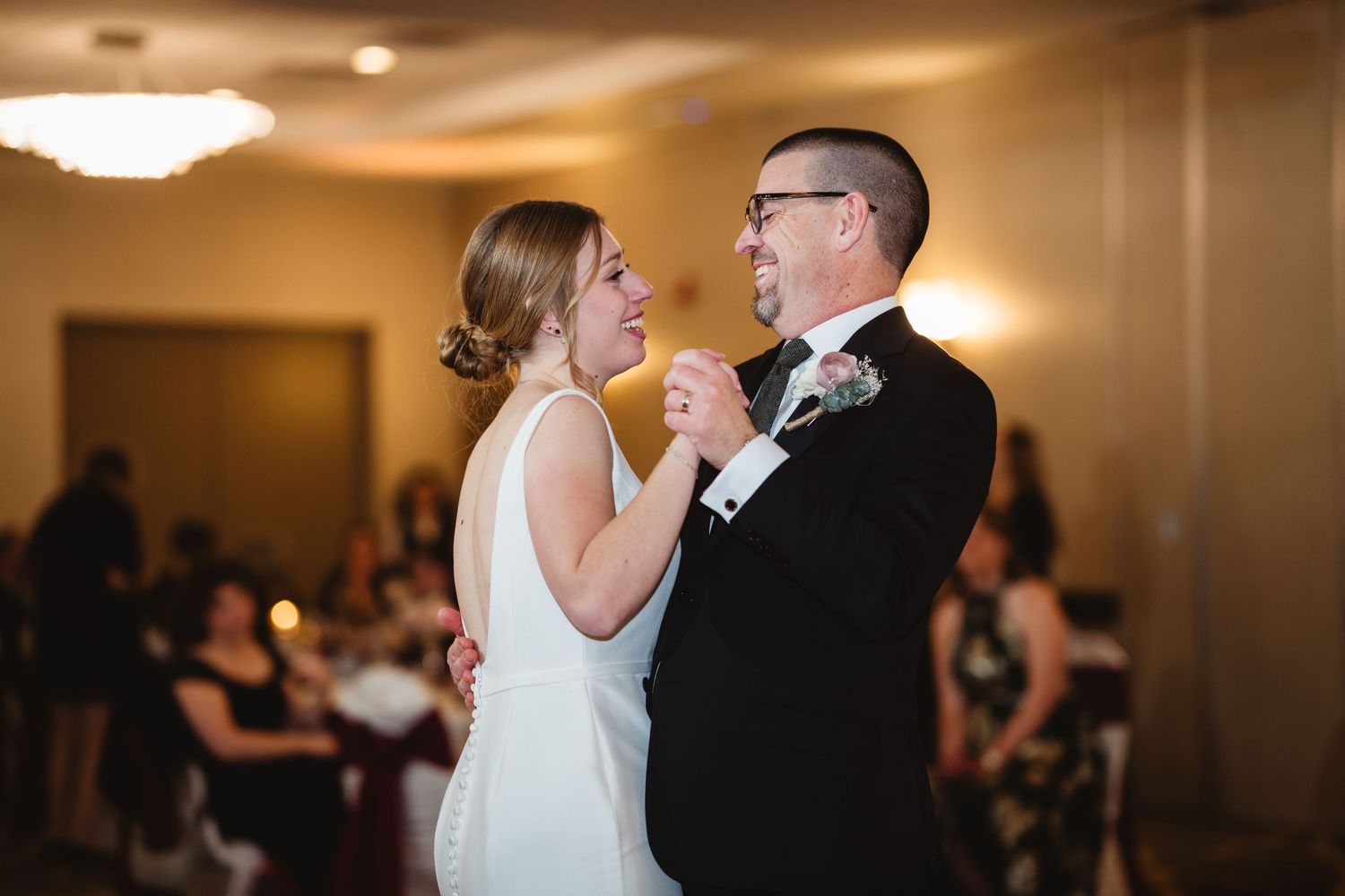 A bride and groom share an intimate dance together during their wedding reception.