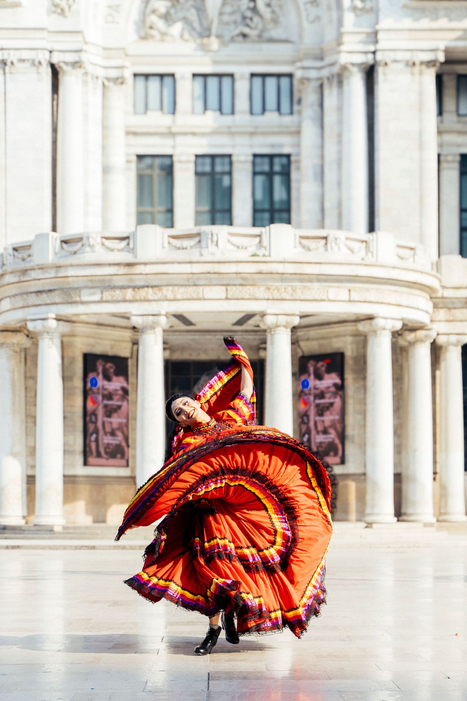 Ballet Folklórico dancer captured in motion with Palacio de Bellas Artes as backdrop
