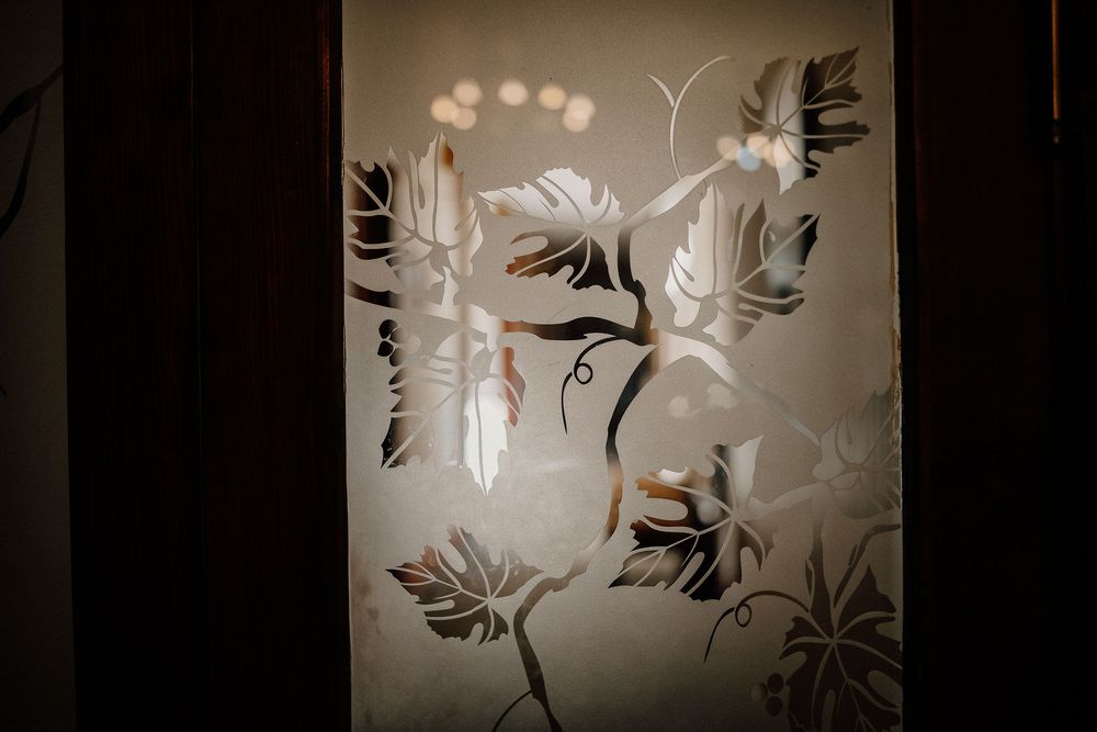 Decorative black and white floral pattern designs on glass panels create an elegant translucent wall display.