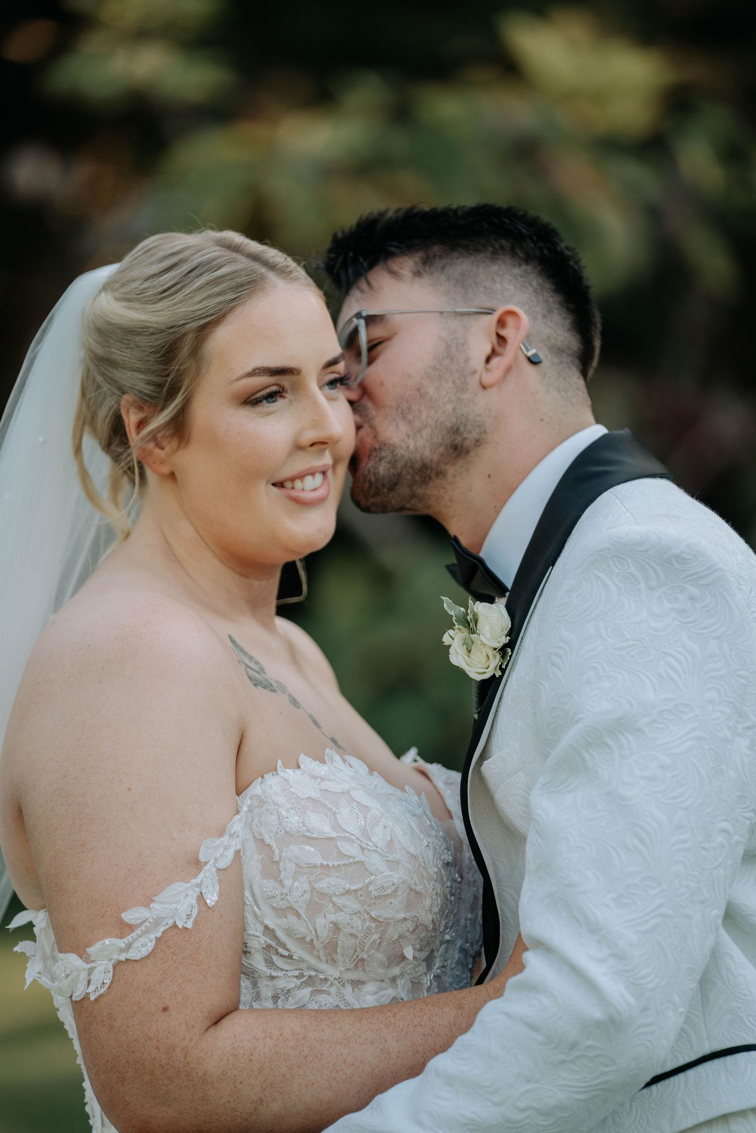A romantic wedding photo series showing tender moments between a bride in lace and groom in black suit outdoors.