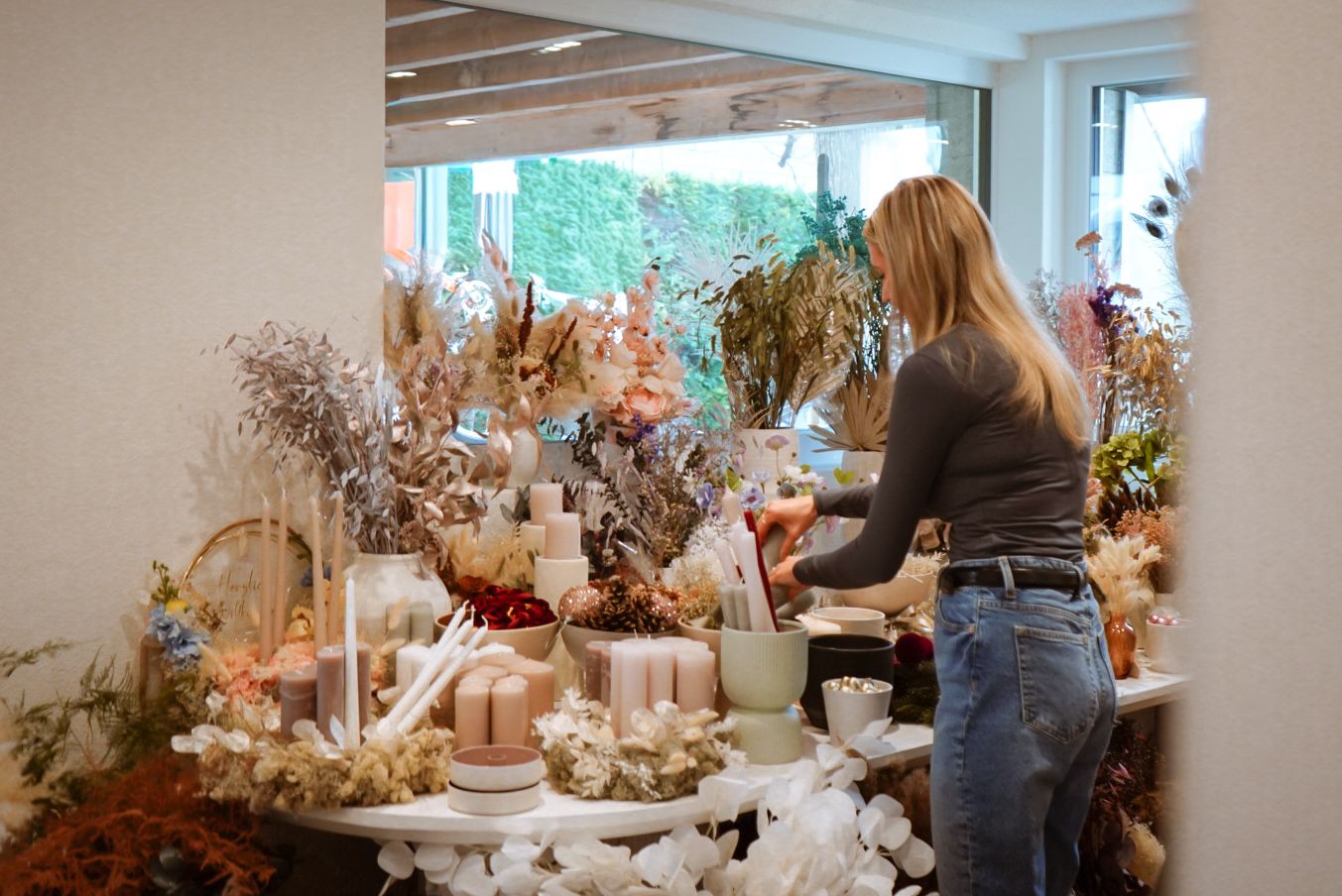 Bright modern interior space decorated with seasonal arrangements and decor.