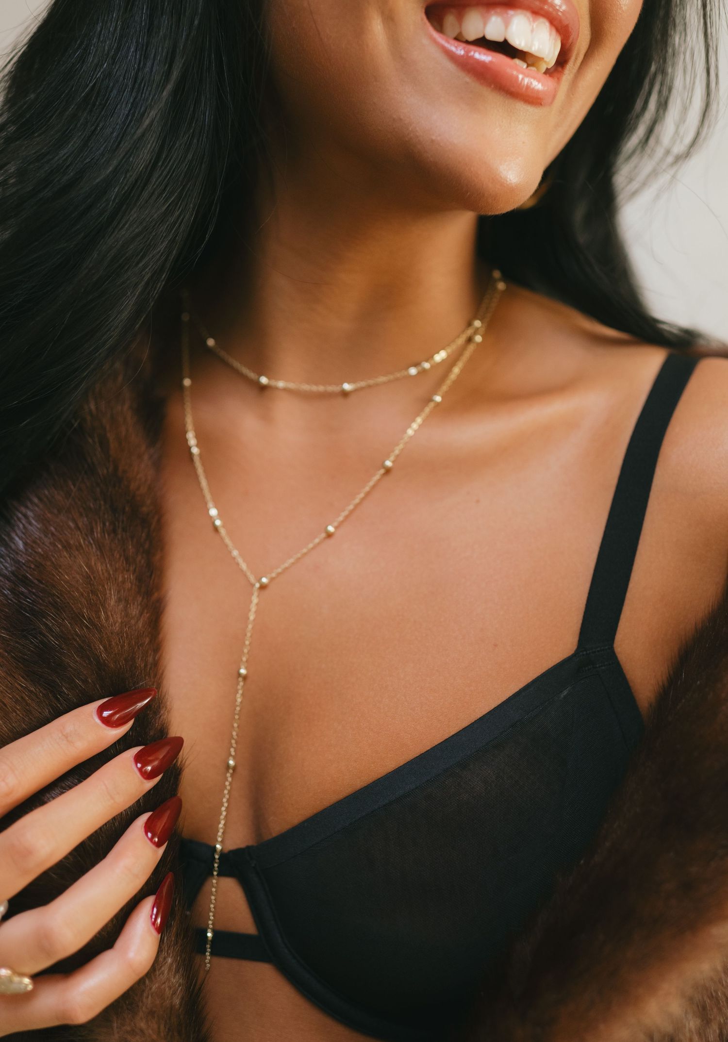 Close-up branding portrait with gold jewelry and red nails by NYC branding photographer