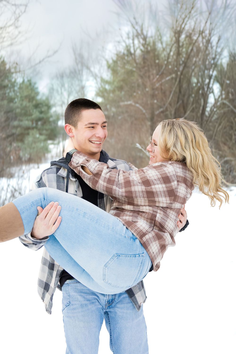Playful, couple portrait, outdoors during winter, natural, and candid lifestyle photography in Michigan