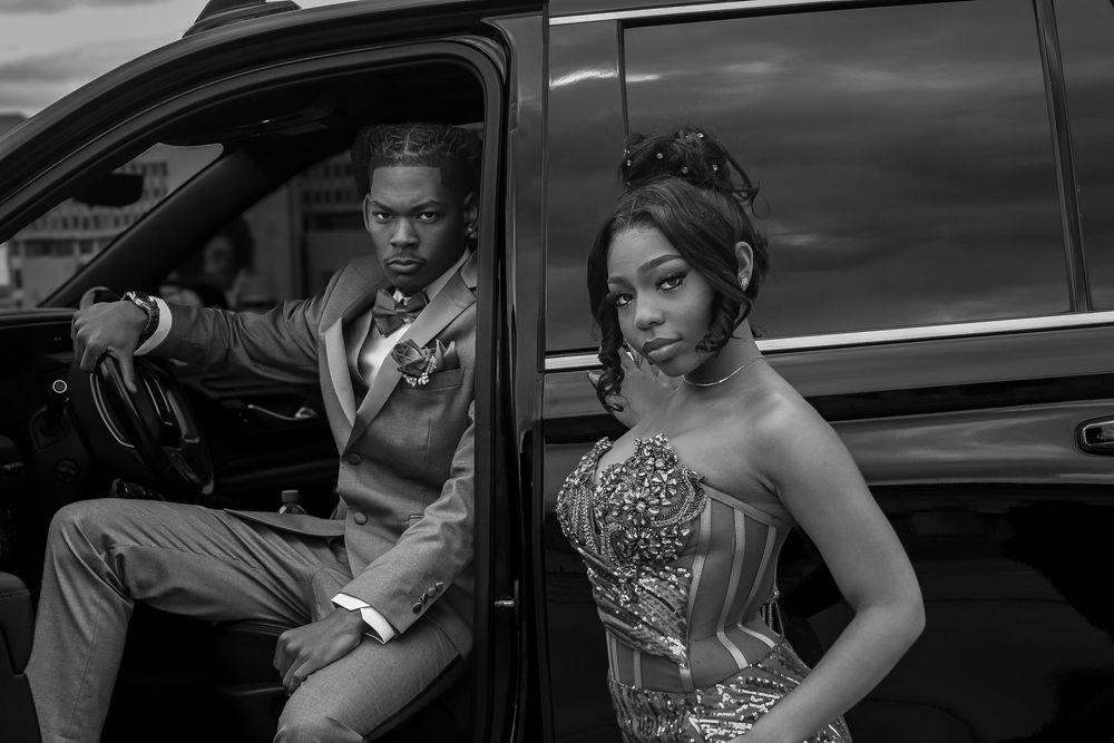 Black-and-white portrait of a couple dressed up for prom with a cinematic, editorial feel during a lifestyle session in Michigan