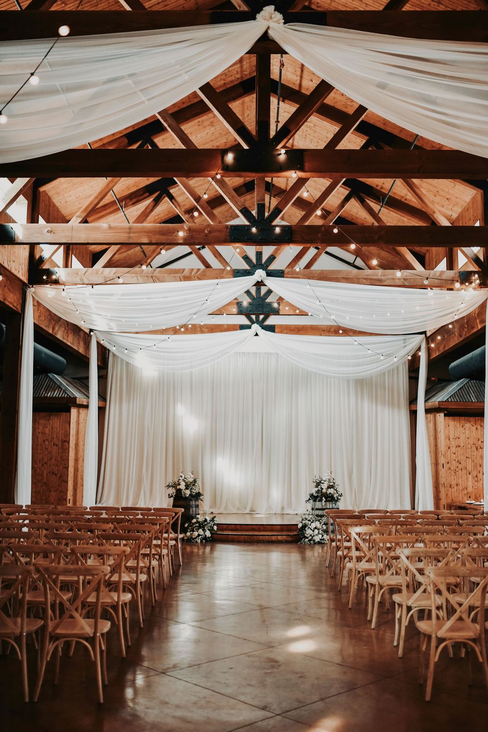 Editorial reception hall at Lucky Spur Ranch with olive and sage florals, candlelit tables, and black-tie ambiance.