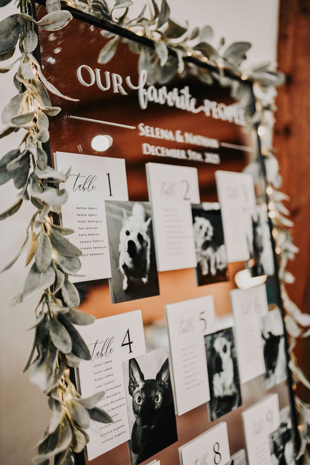 Wedding seating chart display featuring adorable puppy and kitten photos for each guest table.