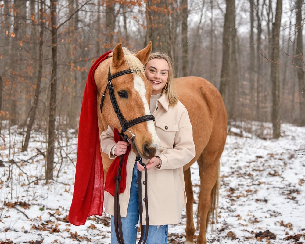 Avery and her palomino horse Vegas during their winter photoshoot.