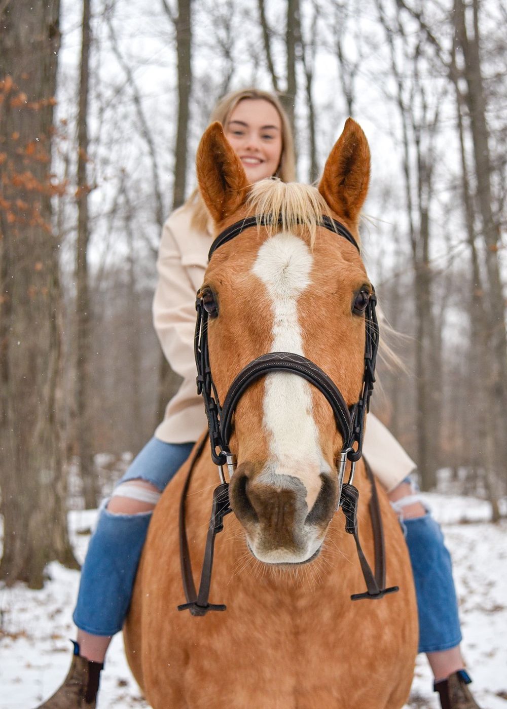 Avery and her palomino horse Vegas during their winter photoshoot.