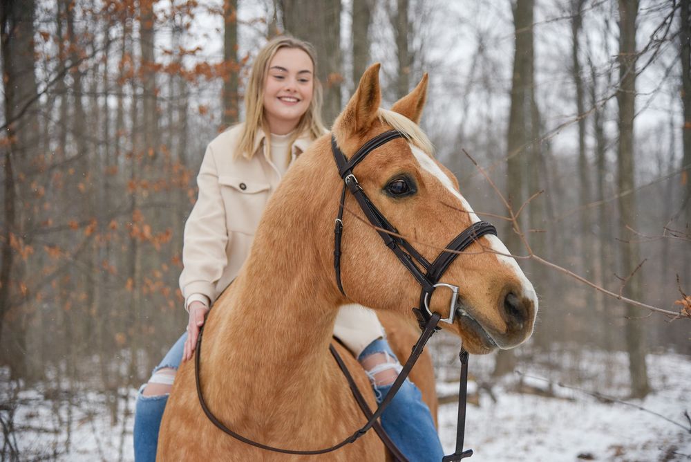 Avery and her palomino horse Vegas during their winter photoshoot.