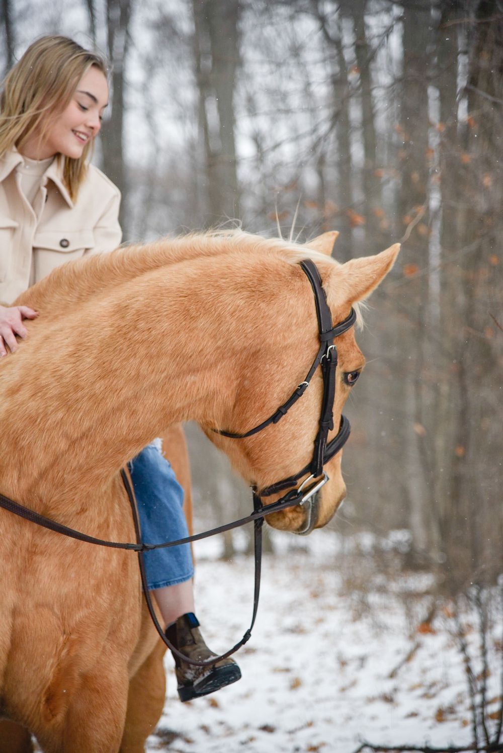 Avery and her palomino horse Vegas during their winter photoshoot.