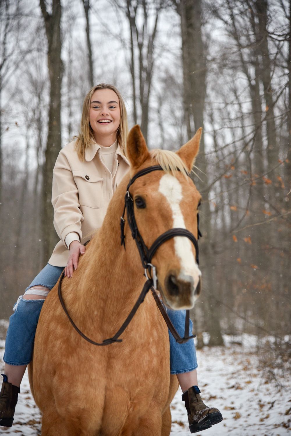 Avery and her palomino horse Vegas during their winter photoshoot.