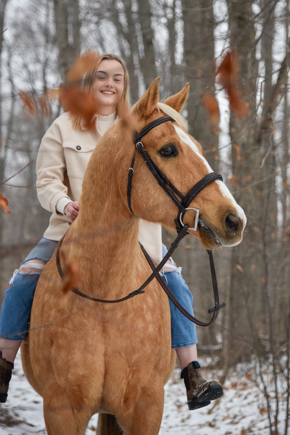 Avery and her palomino horse Vegas during their winter photoshoot.