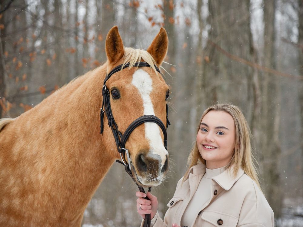 Avery and her palomino horse Vegas during their winter photoshoot.