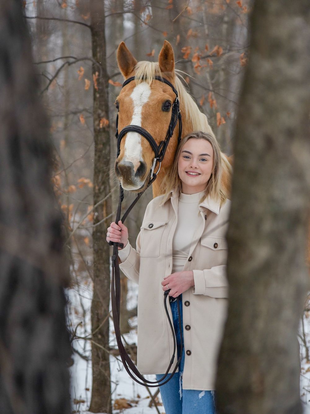 Avery and her palomino horse Vegas during their winter photoshoot.