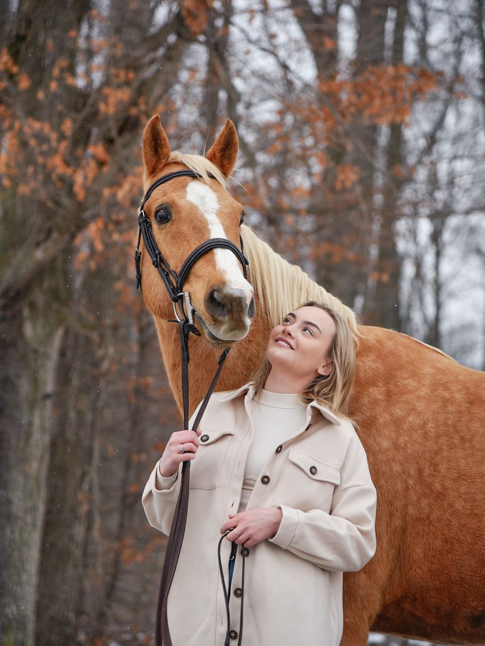 Avery and her palomino horse Vegas during their winter photoshoot.