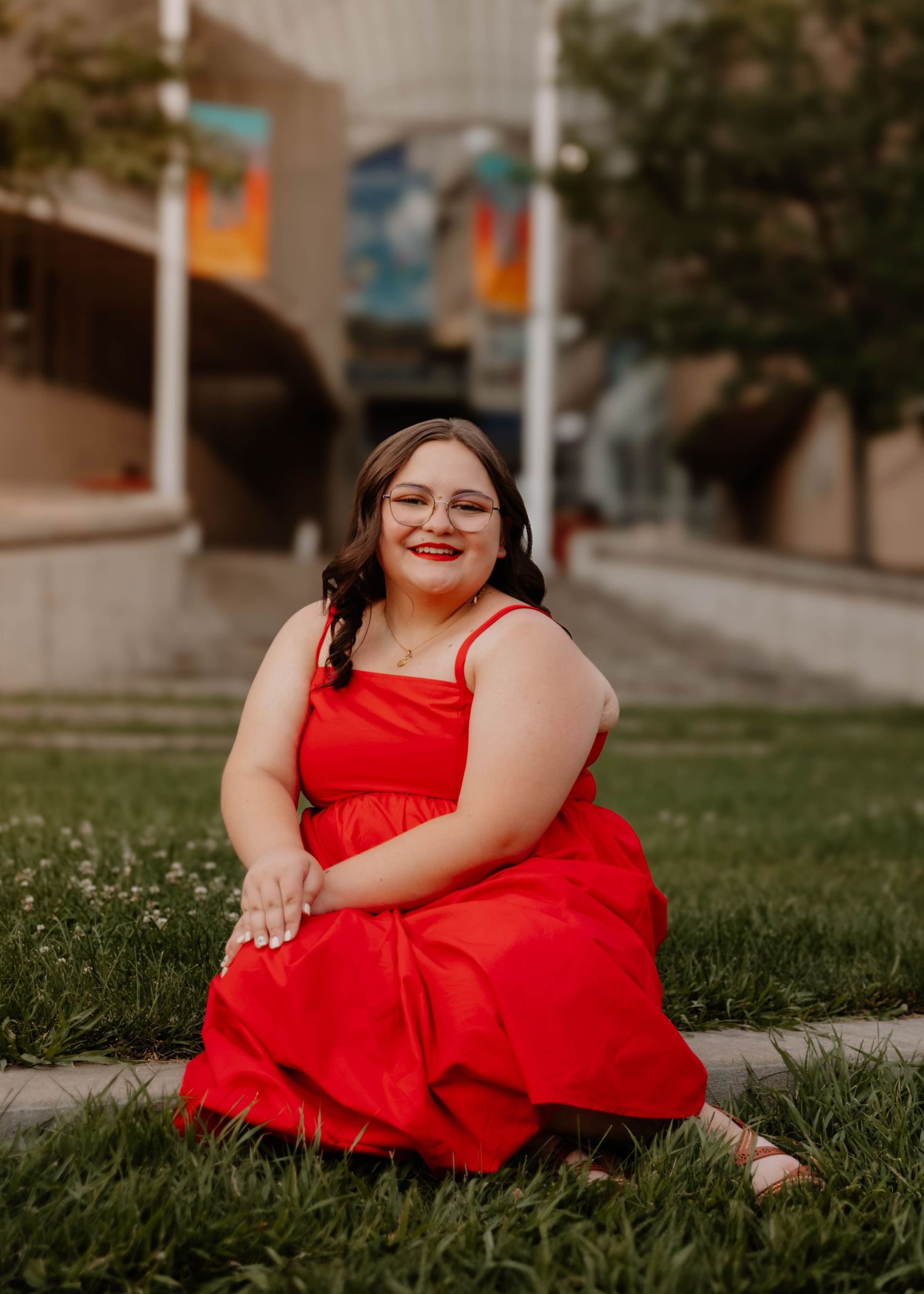 Girl sits and poses for senior photos, cinematic, urban, and portrait photos in Denver, Colorado outside and in nature