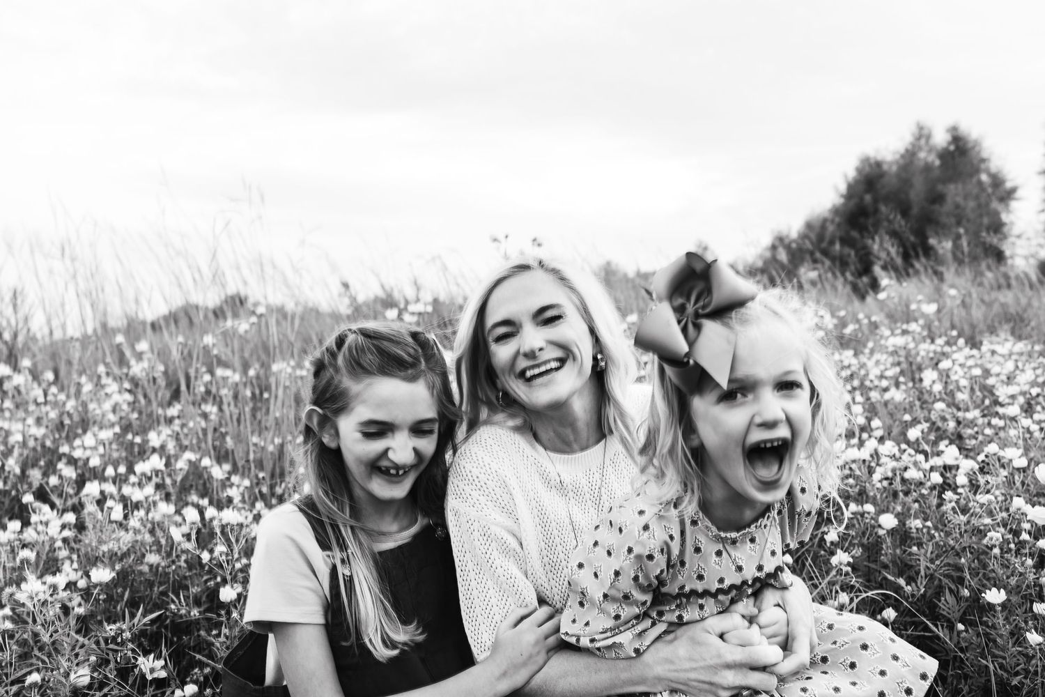 A joyful sequence of candid moments captured in a blooming wildflower meadow on a bright sunny day.