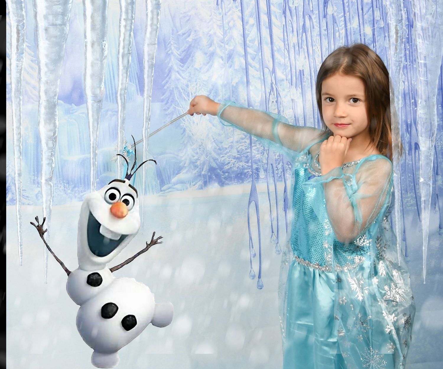 Girl in Elsa costume poses with Olaf snowman character in a Frozen-themed winter wonderland backdrop.