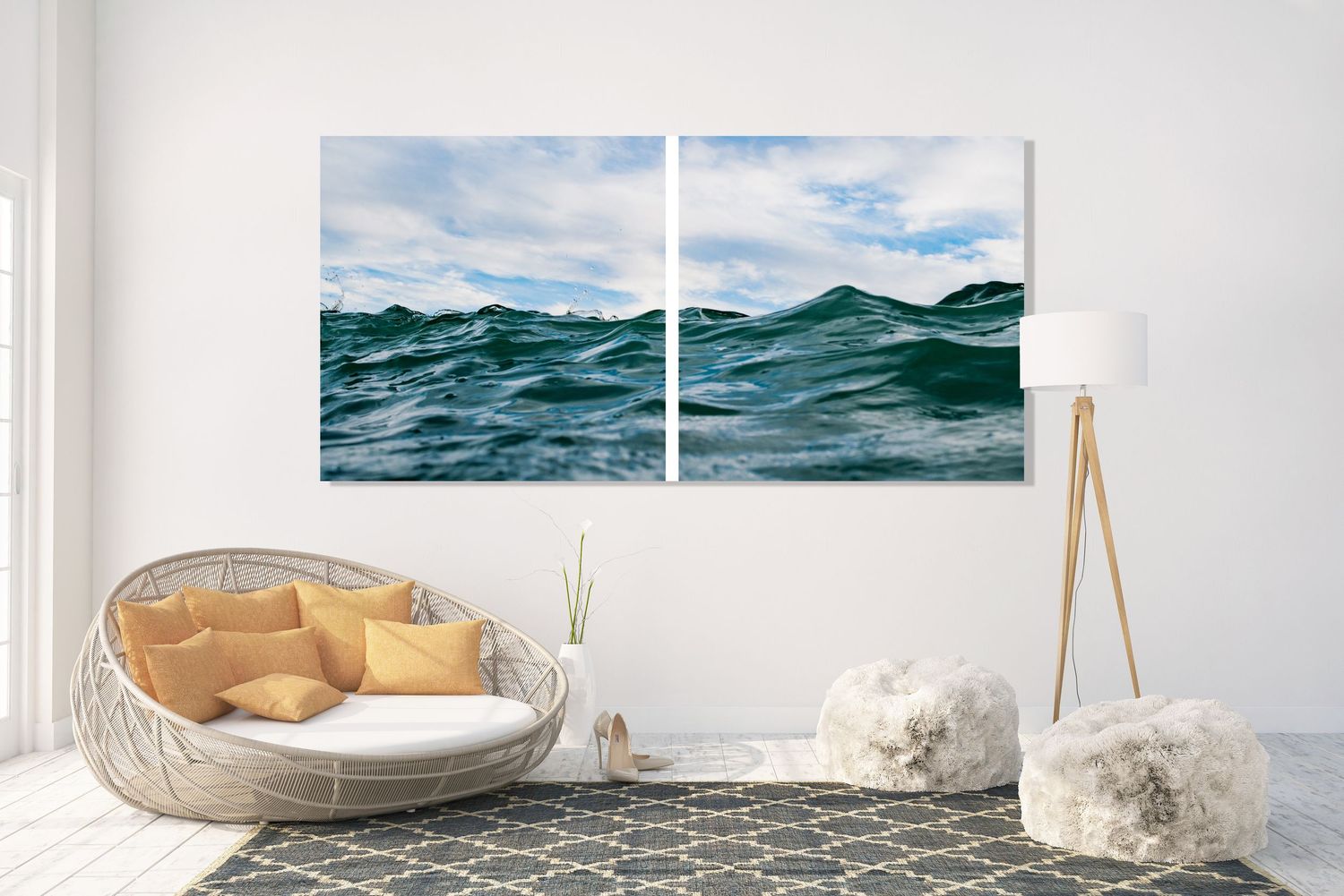 Ocean wave diptych canvas art displayed on a white living room wall above a wicker chair.