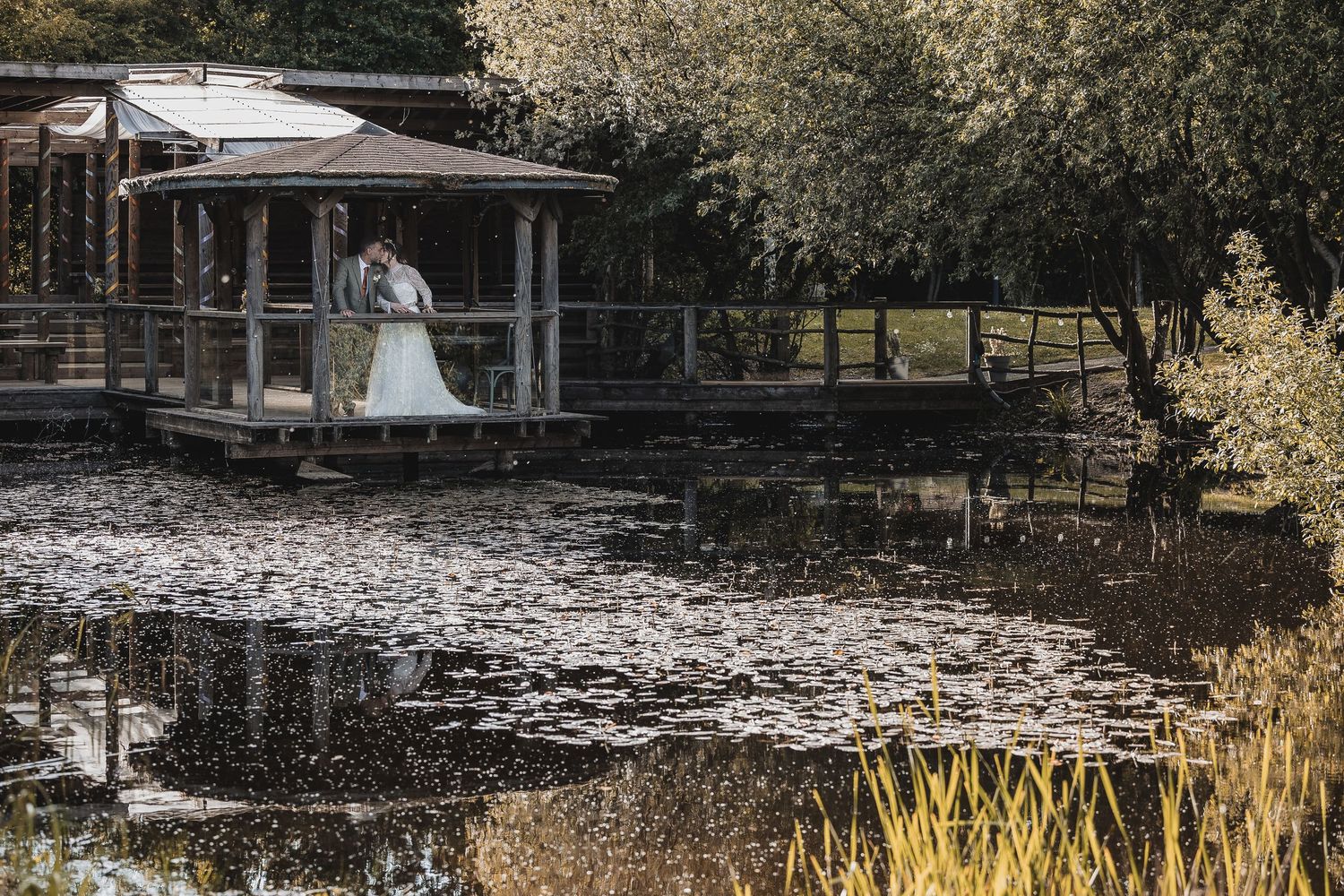 Couple overlooking lake during wedding day.