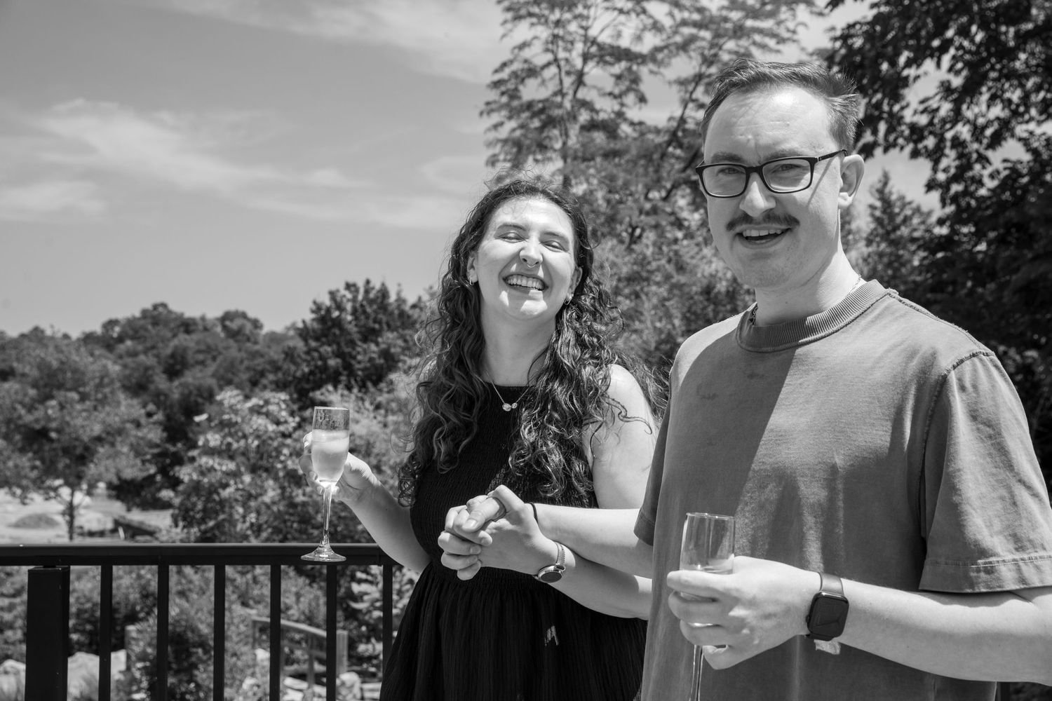 Newly engaged Chad and Teresa toast with champagne while celebrating their surprise proposal at the Cincinnati Zoo.