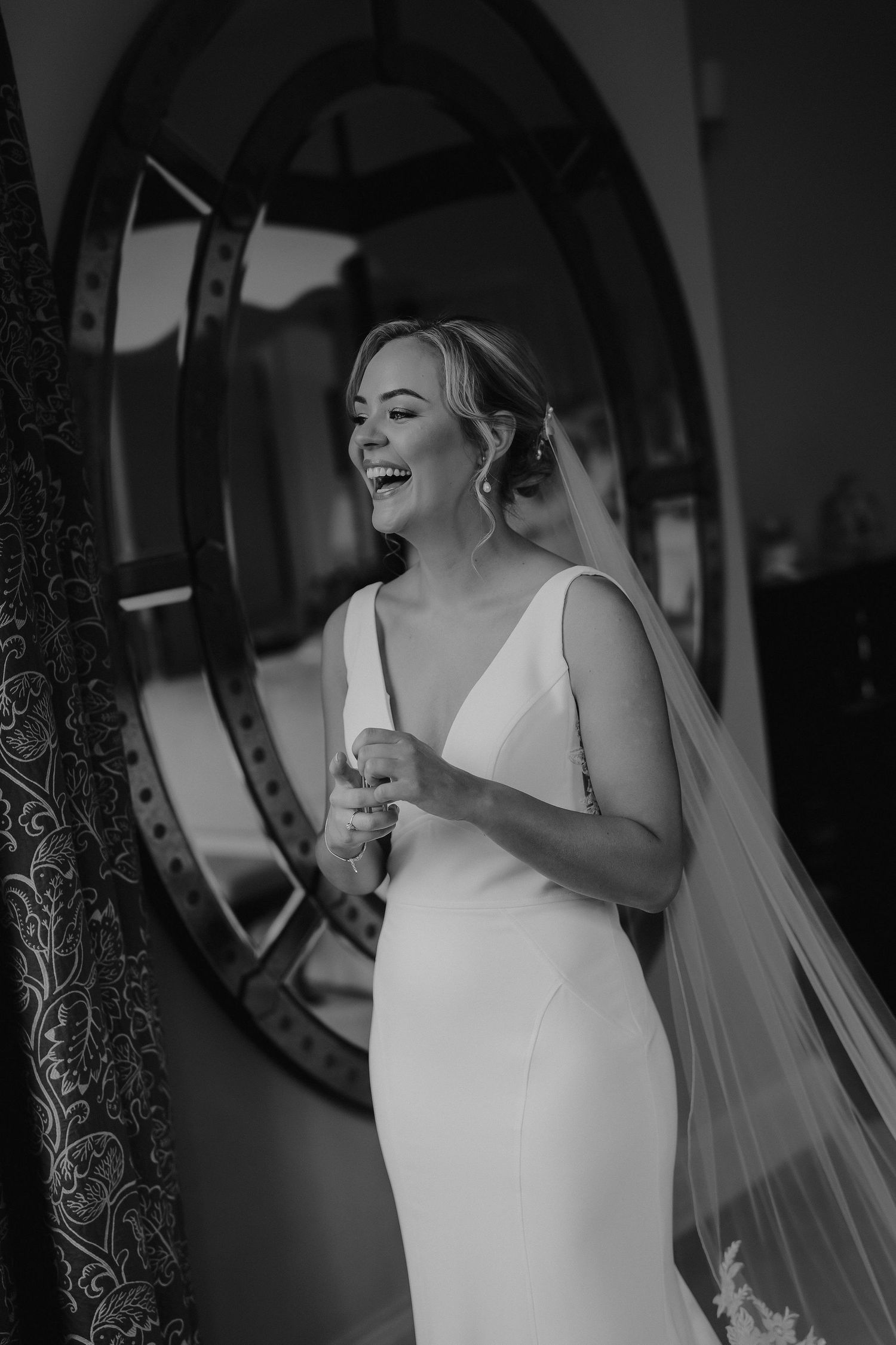 bride laughing in the bridal suite at Iscoyd park