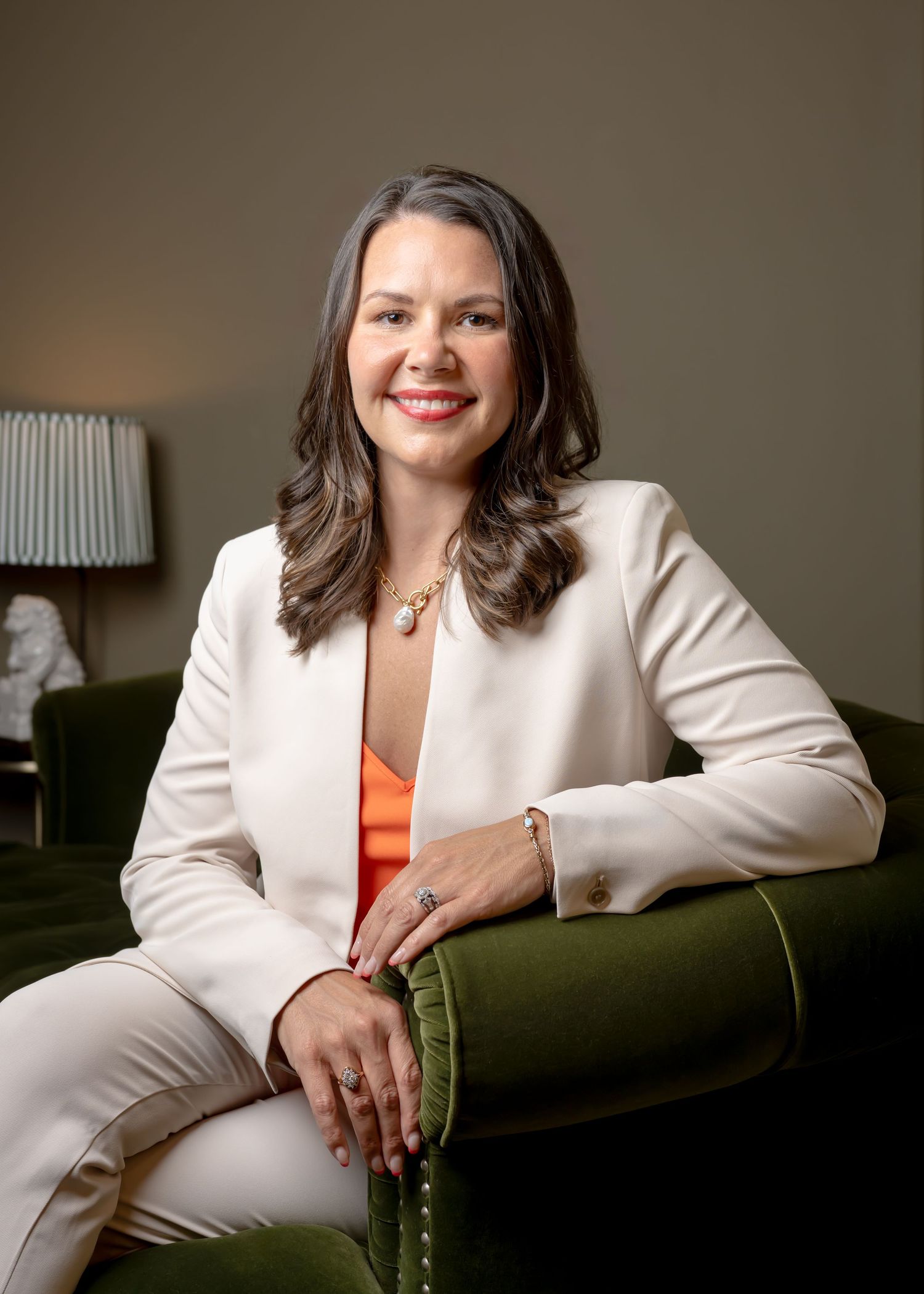 woman professional business portrait sitting on on green couch, birmingham alabama with appears to be in office