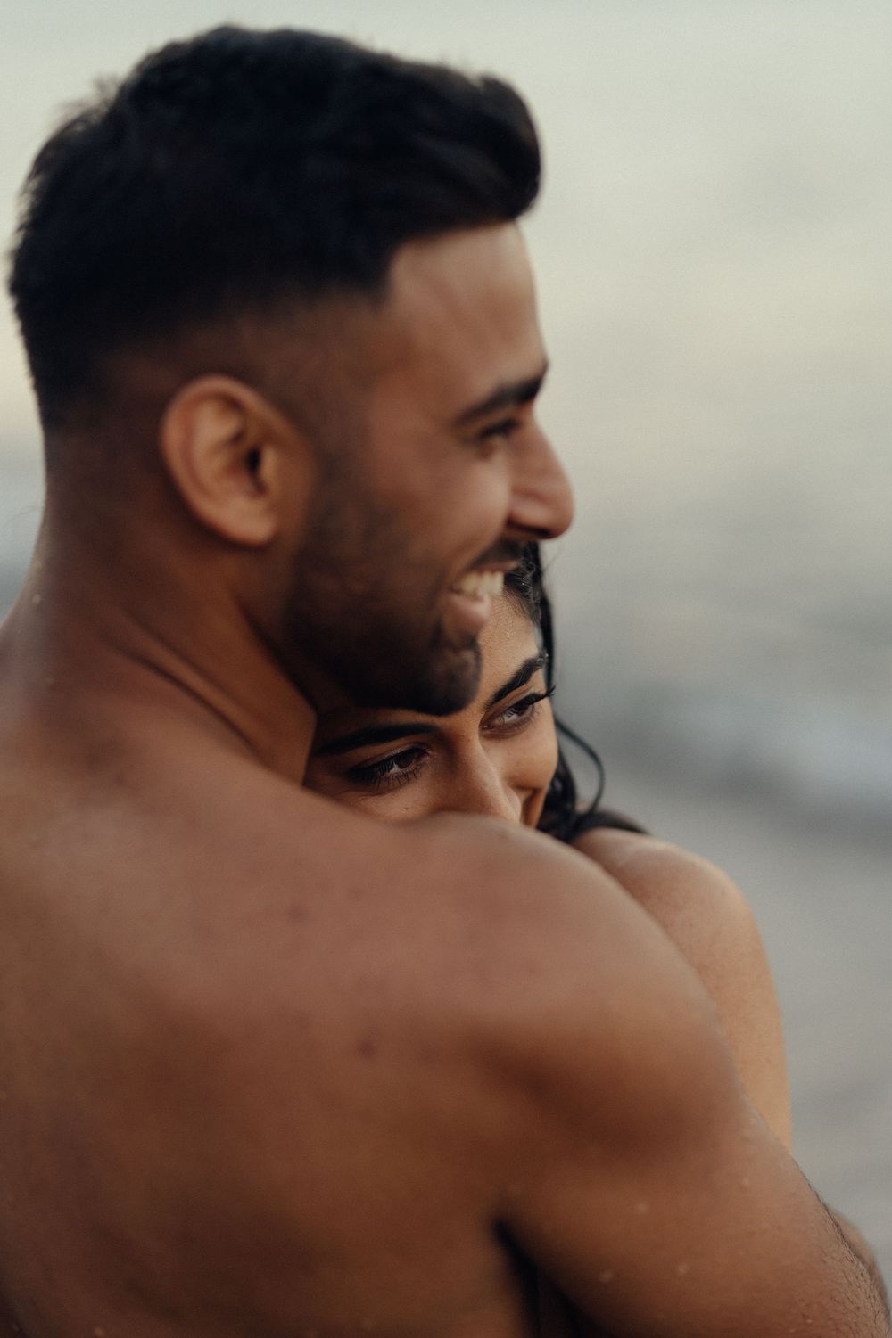 A close-up series showing two people embracing in intimate poses against a blurred background.