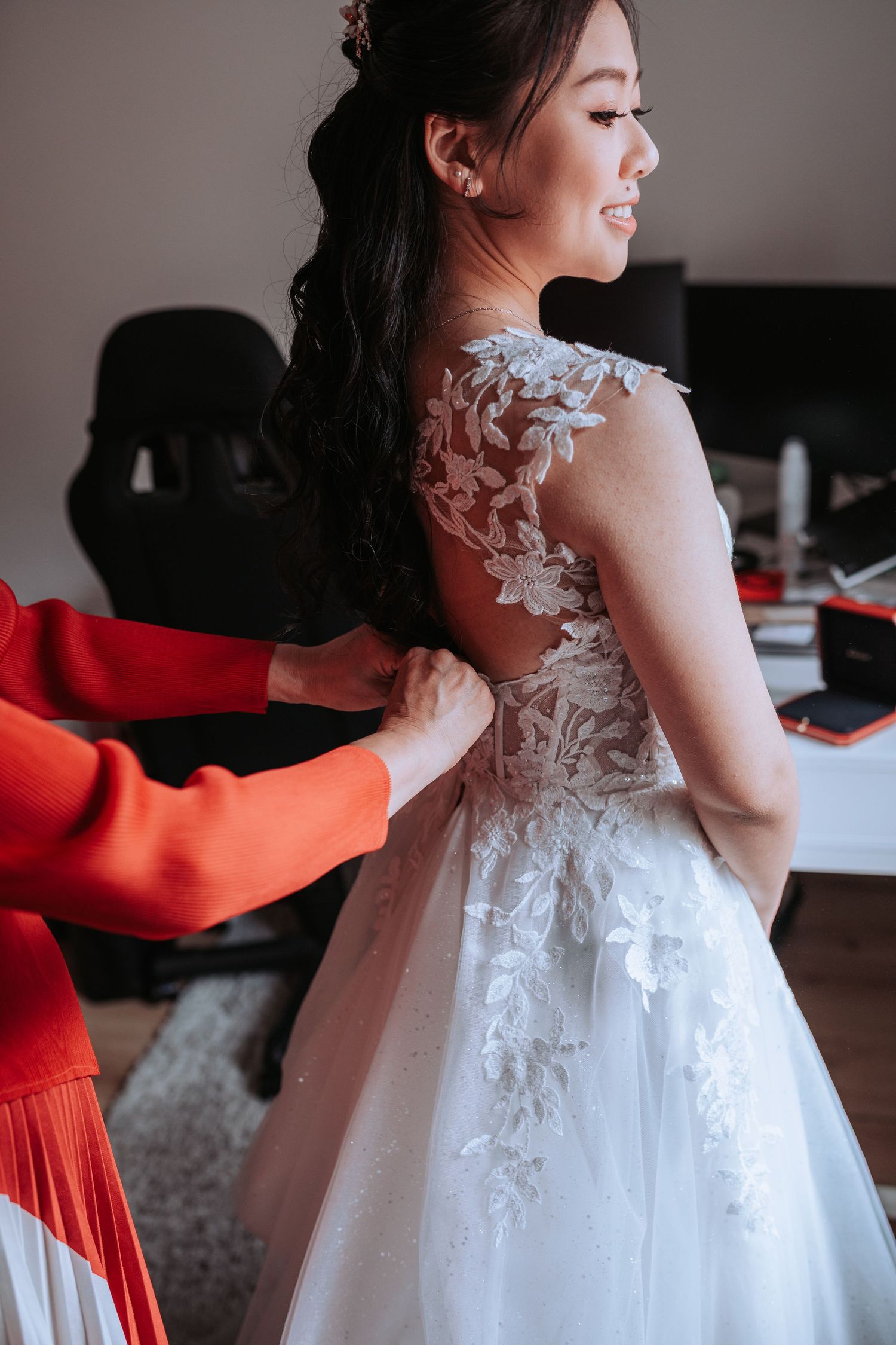 A close-up view of a delicate lace wedding dress with intricate floral details on the back.
