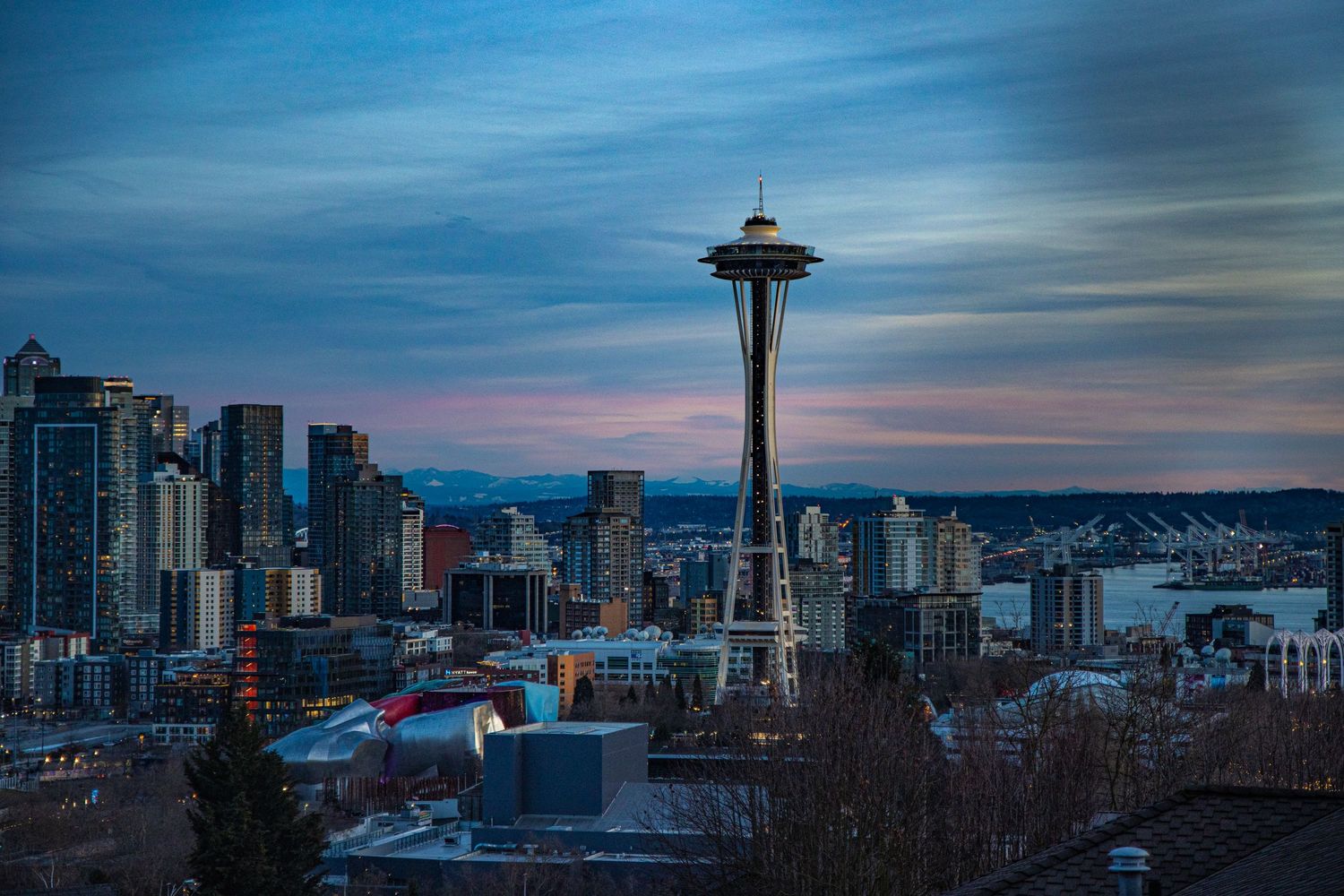 Sunset transitioning to blue hour with the Space Needle and rest of the Seattle city skyline.