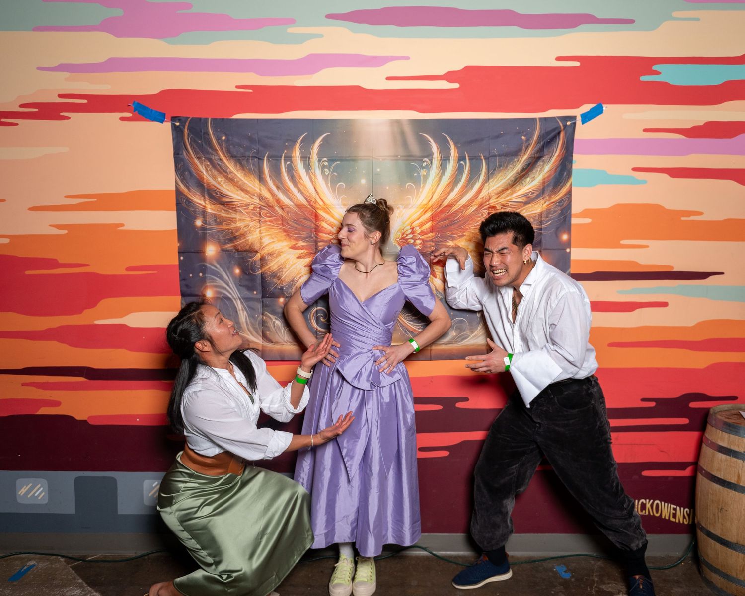 Dancers perform a series of expressive poses against a vibrant sunset backdrop with orange and pink clouds.
