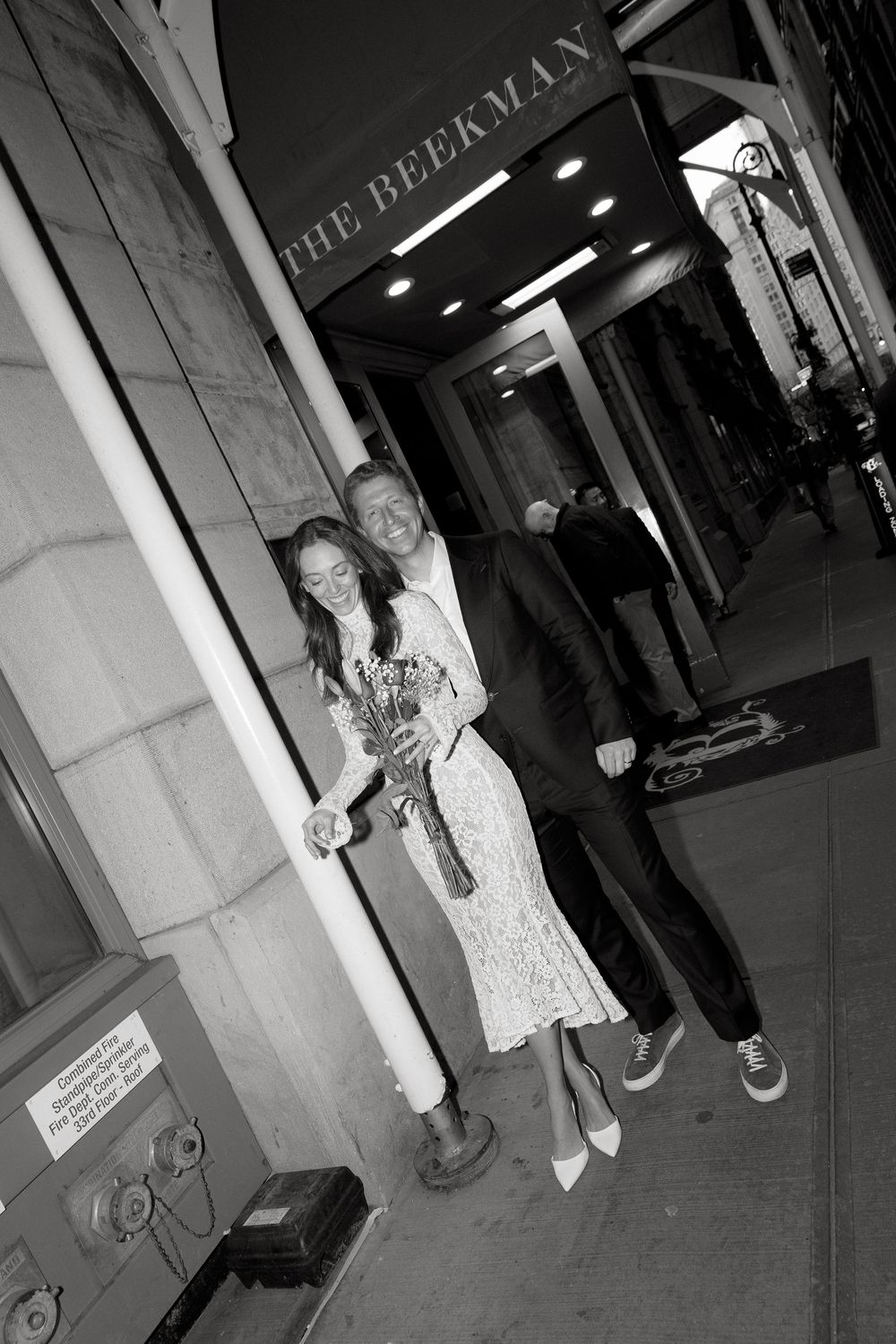 A black and white photo sequence shows people standing near a doorway in what appears to be a building entrance.
