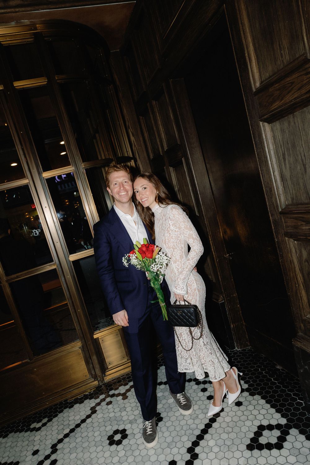 A series of photos on a black and white tiled floor showing a couple with roses in formal attire.