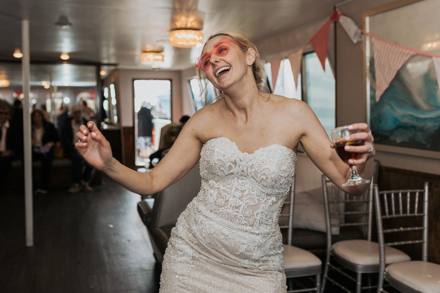 A series of candid reception moments showing a bride dancing and celebrating at an elegant wedding venue on a boat in San Diego.