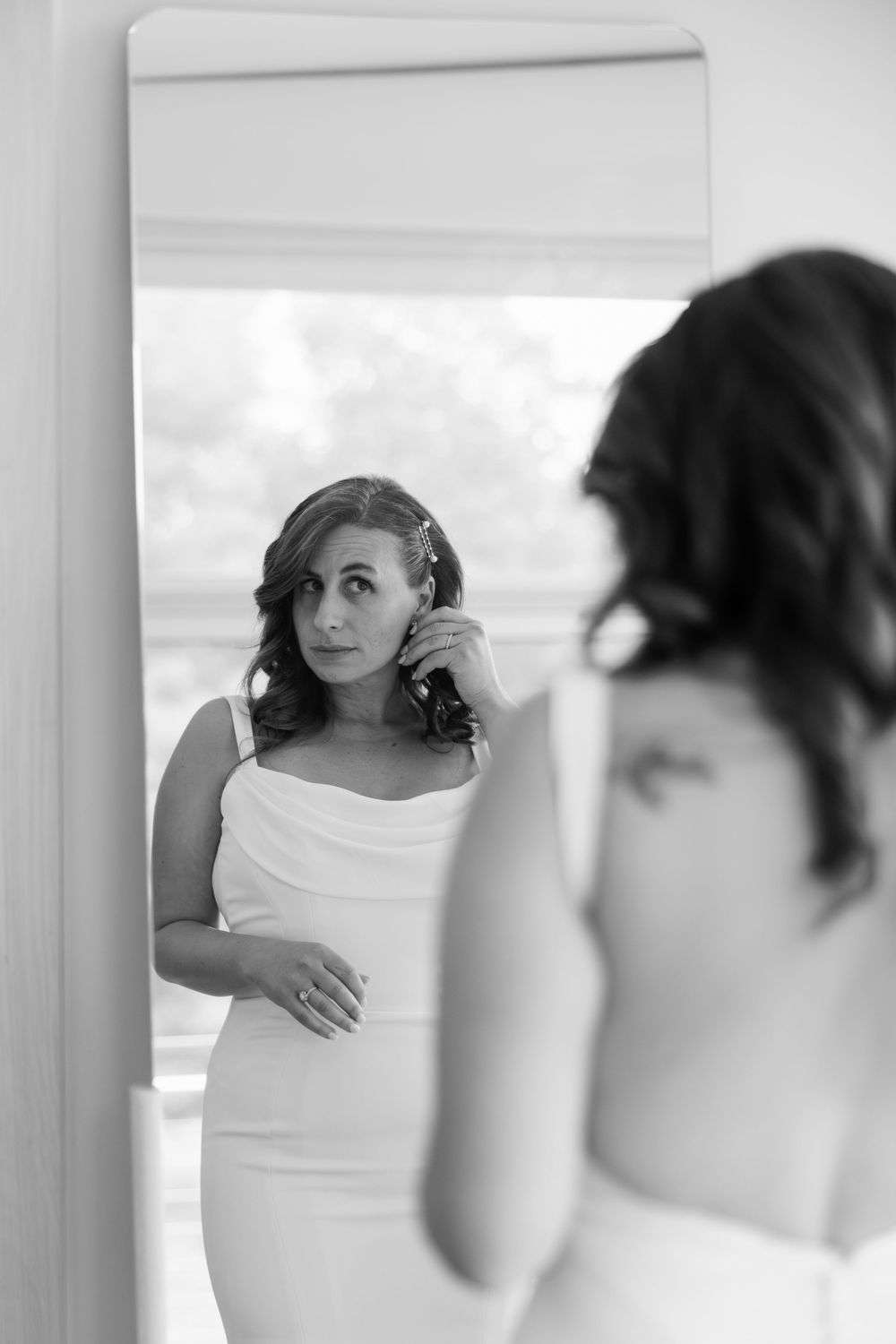 A series of artistic black and white portraits showing intimate moments through window reflections.