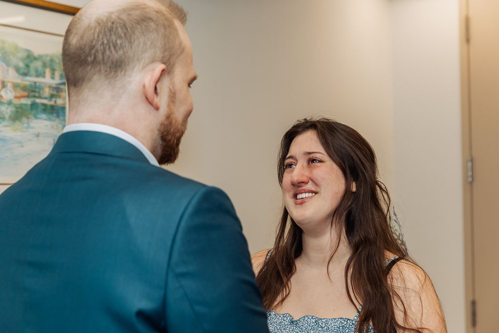 Bride smiling joyfully at her groom during an intimate wedding ceremony in Boston.