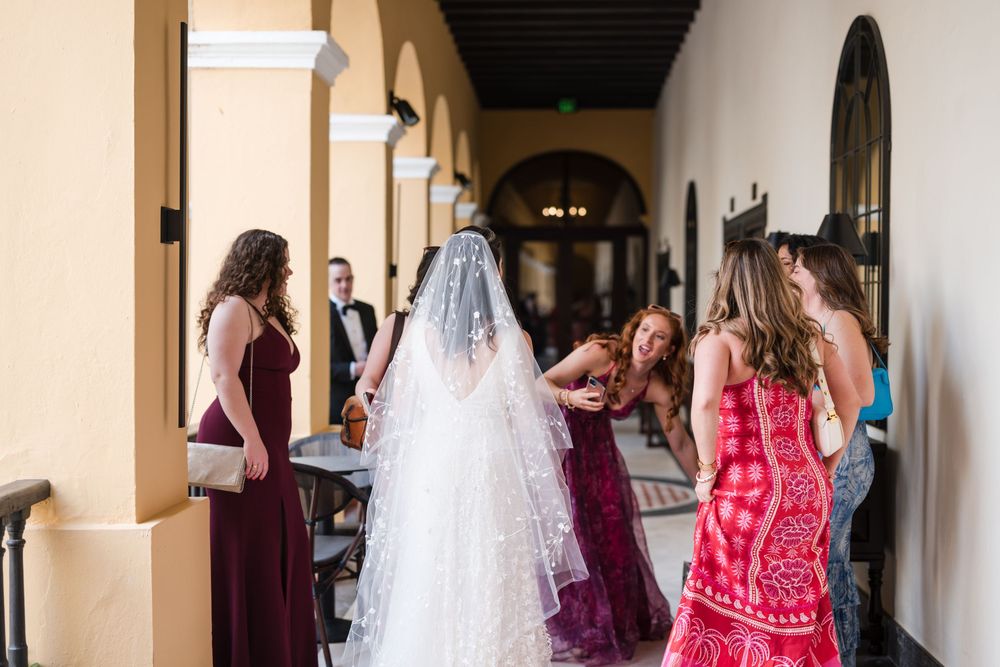 Bride getting ready with bridesmaids in corridor at Hotel El Convento in Old San Juan