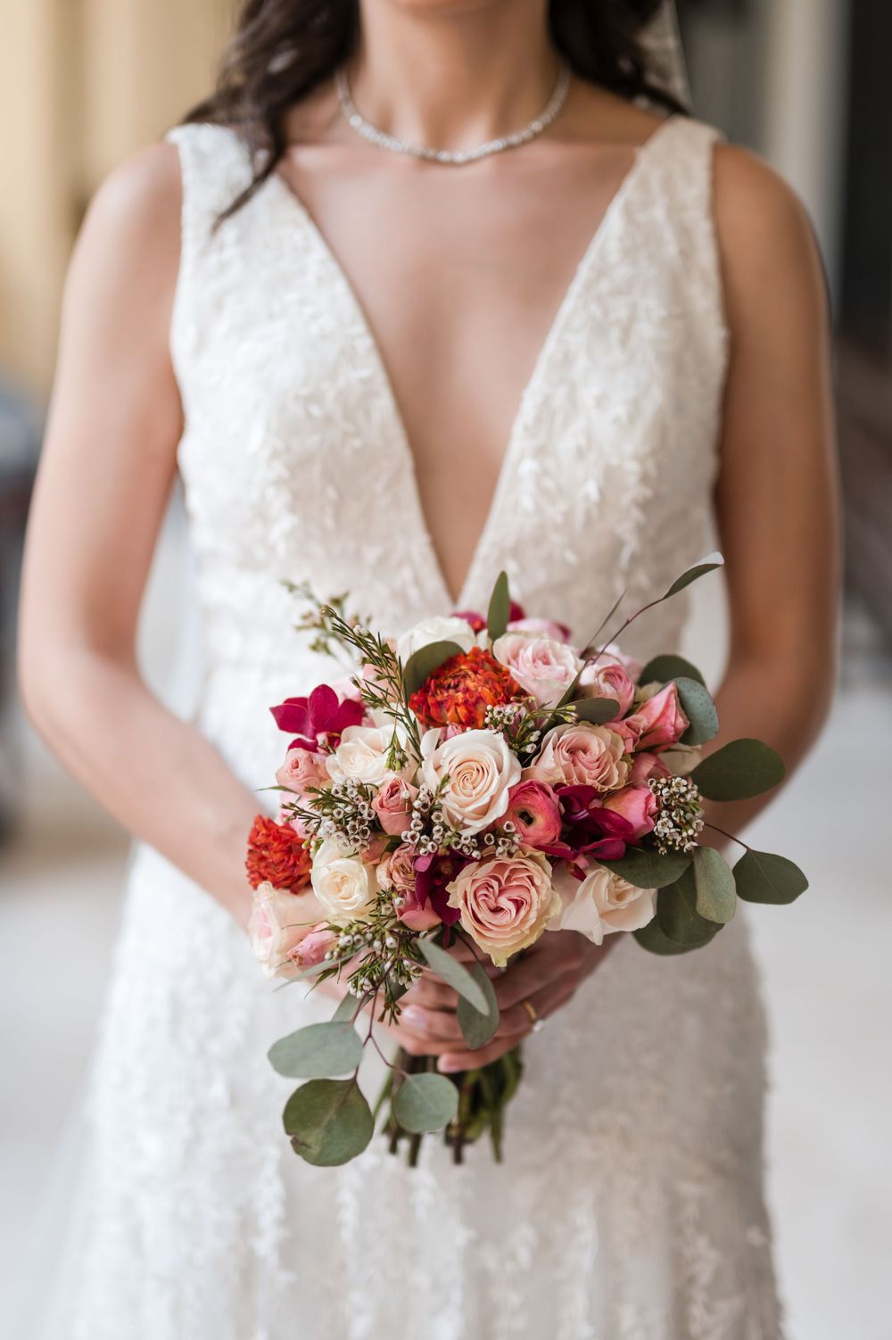 Close up of bride holding bouquet with tropical flowers at Hotel El Convento wedding