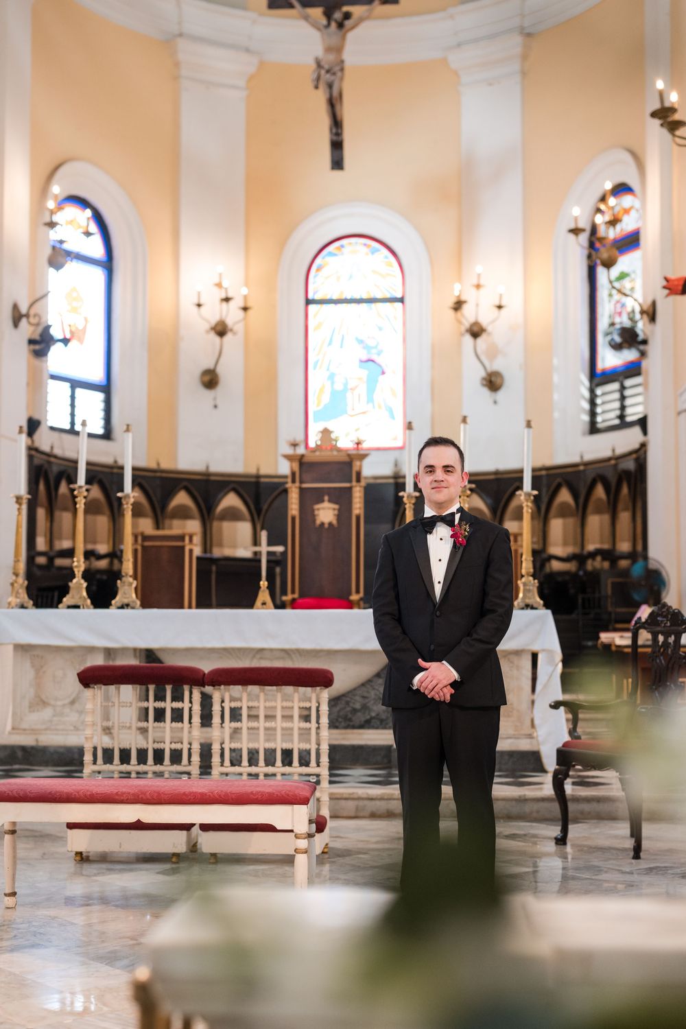 Bride and groom standing at altar inside San Juan Cathedral during wedding ceremony