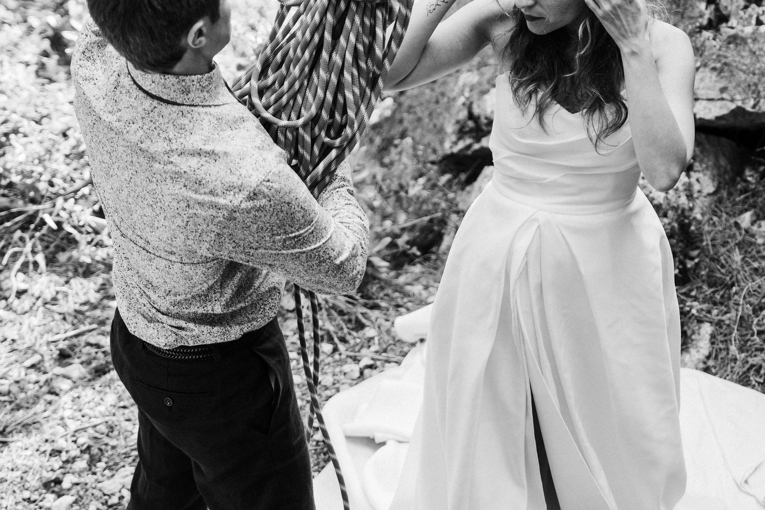 A black and white photo collage showing tender moments between a couple during a romantic outdoor photoshoot.