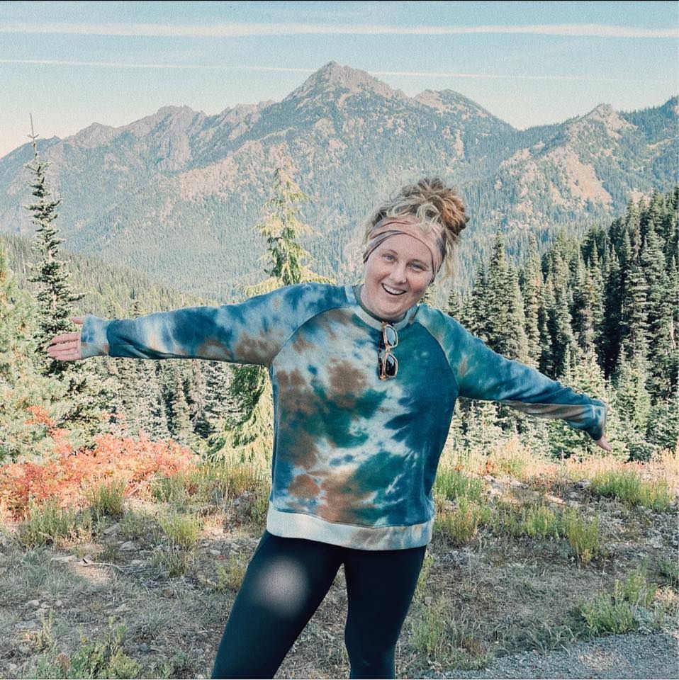 Tori Shults, the owner of Pine + Vow, in front of mountain range at Hurricane Ridge in Olympic National Park